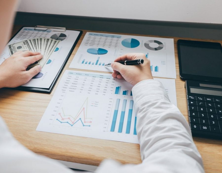 businessman working on a graph document financial report and analysis calculation investment cost e1637859084950 pglcfqs5s67q271uo7g1jokvscu9zseqnyuz6s6ogo